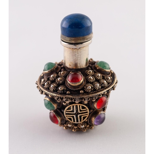 33 - A SMALL GILT METAL CABOCHON STONE ENCRUSTED SNUFF BOTTLE, the blue stone stopper with bone spoon