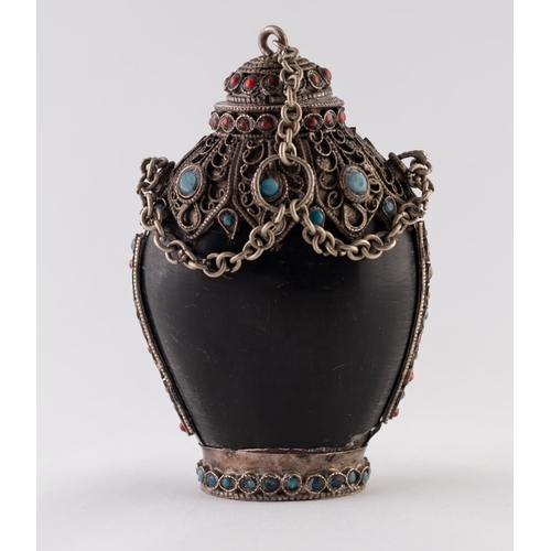 35 - A POSSIBLY HORN, WHITE METAL AND FAUX JEWEL ENCRUSTED SNUFF BOTTLE, with chain attached stopper and ... 