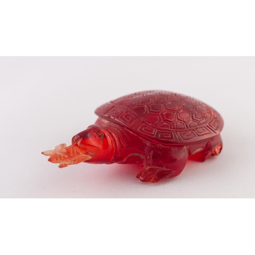 27 - A RED BURMESE AMBER SNUFF BOTTLE IN THE FORM OF A TURTLE, a butterfly in its mouth, a removable stop... 