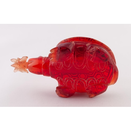 27 - A RED BURMESE AMBER SNUFF BOTTLE IN THE FORM OF A TURTLE, a butterfly in its mouth, a removable stop... 