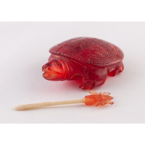 27 - A RED BURMESE AMBER SNUFF BOTTLE IN THE FORM OF A TURTLE, a butterfly in its mouth, a removable stop... 