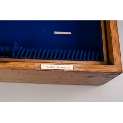 747 - AN OAK CANTEEN LINED WITH ROYAL BLUE VELOUR with a removable tray, inset with bone tablets inscribed... 