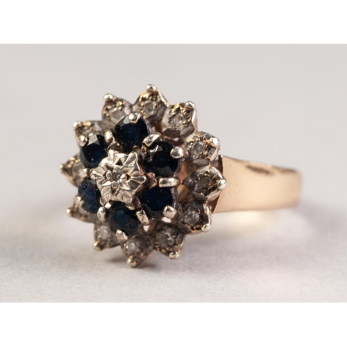 317 - 9ct GOLD DIAMOND AND SAPPHIRE THREE TIER CLUSTER RING,  set with a tiny centre diamond, surround of ... 