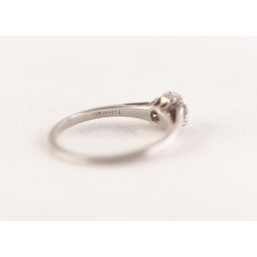 366 - PLATINUM SOLITAIRE DIAMOND RING. An old cut diamond in a double claw setting, to scroll shoulders, e... 