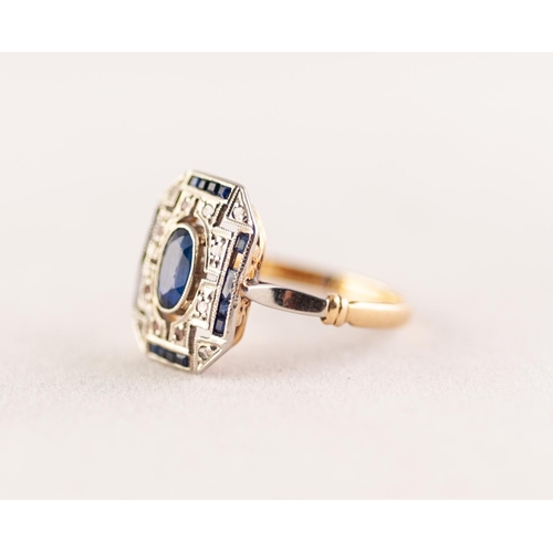 367 - EDWARDIAN SAPPHIRE AND DIAMOND PLAQUE RING. An oval cut sapphire within a pierced plaque set with si... 