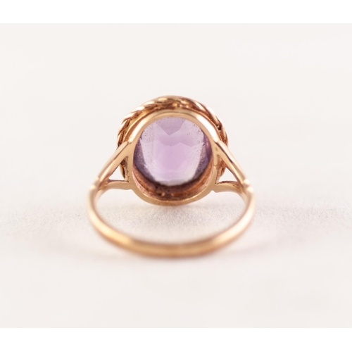 368 - 9ct GOLD AMETHYSY RING. Oval amethyst in a rope frame, to forked shoulders, ring size K1/2, 3.24g