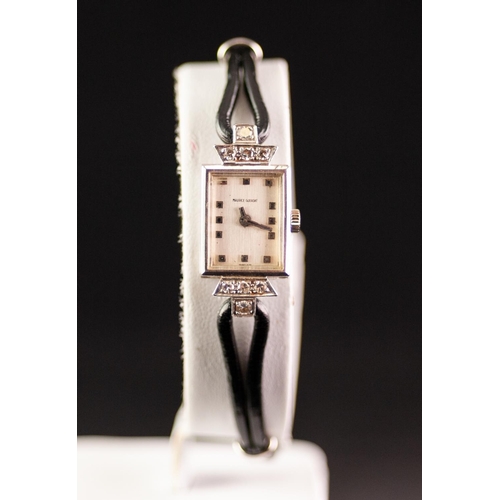 118 - AN 18ct GOLD CASED MAURICE GUERDAT LADY'S WRIST WATCH, set with eight tiny diamonds, on a black cord... 