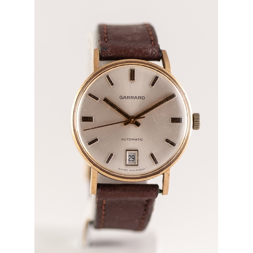 36 - GENTS GARRARD GOLD WRIST WATCH with Swiss automatic movement, circular silvered dial with batons cen... 