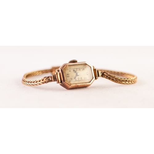 83 - LADY'S 9ct GOLD WRISTWATCH with jewelled movement, narrow rectangular silvered arabic dial with cant... 