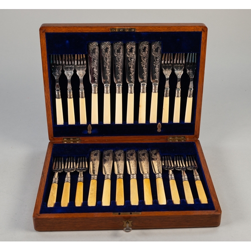 748 - AN EDWARDIAN OAK CASED SET OF TWELVE PAIRS OF PLATED FISH KNIVES AND FORKS, with bone handles