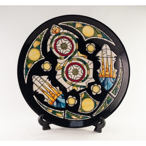 41 - MODERN MOORCROFT ARTIST SIGNED LIMITED EDITION TUBE LINED POTTERY CIRCULAR PLAQUE, of slightly dishe... 