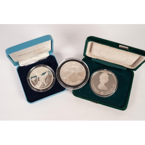 62 - AMERICAN SILVER DOLLAR, 2003, together with AN ELIZABETH II CALGARY OLYMPICS SILVER 20 DOLLAR COIN, ... 