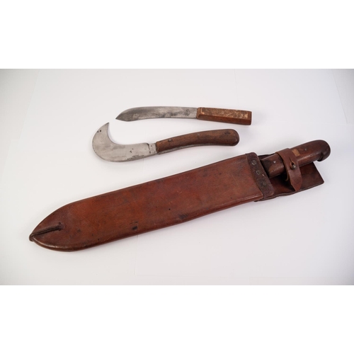 72 - ‘WILSON’ BLADED MACHETE WITH BROWN LEATHER SCABBARD and stained wood handle, 15” (38.cm) long, toget... 