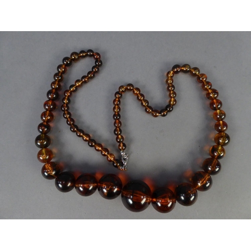 350 - RECONSTITUTED DARK GOLD BROWN AMBER SINGLE STRAND NECKLACE of graduated round beads, 30