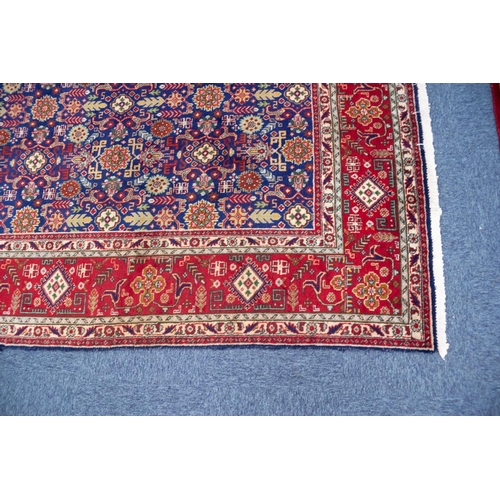 9 - TABRIZ PERSIAN CARPET with all-over repeat formal floral, leaf and ram's horn patetrn on a dark blue... 