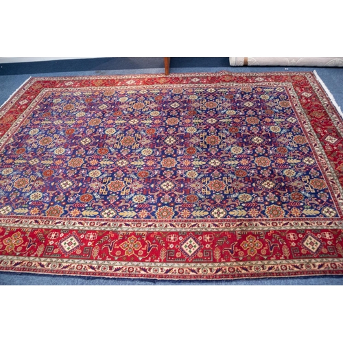 9 - TABRIZ PERSIAN CARPET with all-over repeat formal floral, leaf and ram's horn patetrn on a dark blue... 