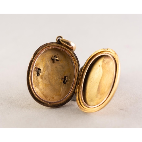 91 - VICTORIAN GOLD COLOURED EMTAL OVAL LOCKET PENDANT, the front applied with a horseshoe shaped setting... 