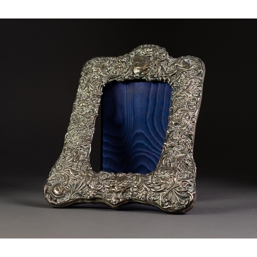 234 - EASEL PHOTOGRAPH FRAME WITH STAMPED SILVER FRONT repousse with putto, dog chasing a rabbit, birds an... 