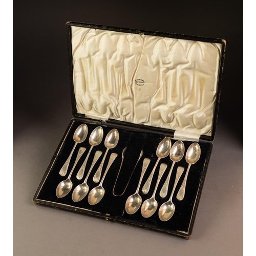 218 - GEORGE V CASED SET OF TWELVE SILVER TEASPOONS AND MATCHING PAIR OF SUGAR TONGS, with bright cut hand... 