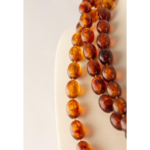 72 - TRANSLUCENT AMBER NECKLACE, formed of 109 small well-matched beads, 42.8 gms gross