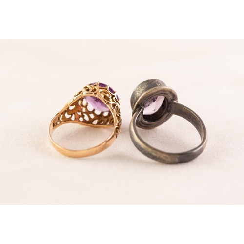 51 - UNMARKED GOLD COLOURED METAL RING, the raised openwork setting with a circular amethyst, 4.3 gms gro... 
