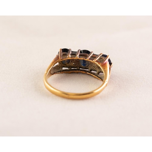 41 - 18ct GOLD RING set with three dark sapphires divided with four tiny diamonds, 4.1 gms