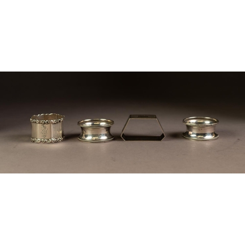 223 - FOUR SILVER NAPKIN RINGS, comprising: A PAIR, Birmingham 1923, ANOTHER, octagonal, marks rubbed and ... 