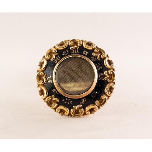 36 - VICTORIAN GOLD AND BLACK ENAMELLED CIRCULAR BROOCH with glazed hair locket to the front, the black e... 