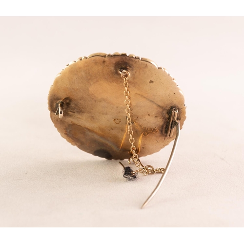 36 - VICTORIAN GOLD AND BLACK ENAMELLED CIRCULAR BROOCH with glazed hair locket to the front, the black e... 
