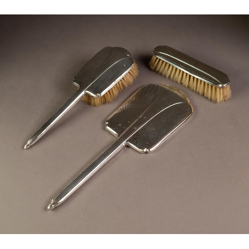 200 - THREE PIECE ENGINE TURNED AND ENGRAVED SILVER BACKED THREE PIECE DRESSING TABLE HAND MIRROR AND BRUS... 