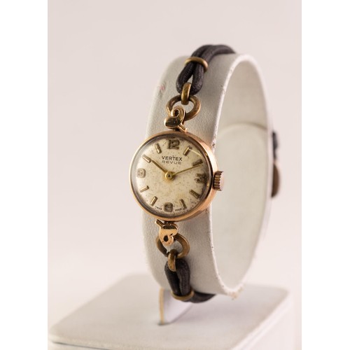 28 - LADY'S VERTEX REVUE 9ct GOLD WRISTWATCH with small circular silvered dial with four arabic numerals ... 