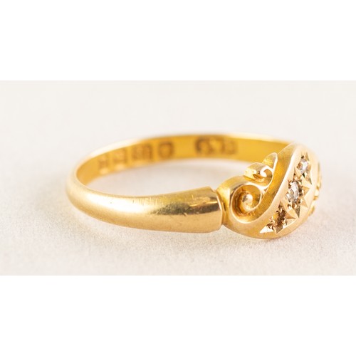 101 - AN EDWARDIAN 18ct GOLD RING, with two tiny rose diamonds in a scroll pattern cross setting (one diam... 