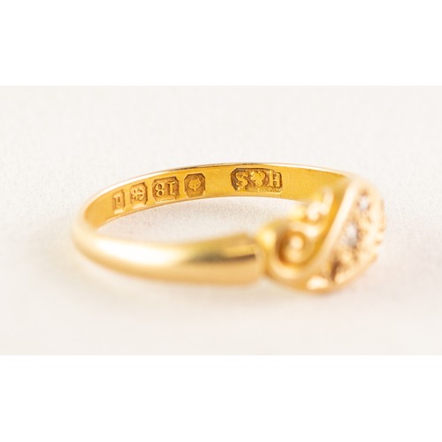 101 - AN EDWARDIAN 18ct GOLD RING, with two tiny rose diamonds in a scroll pattern cross setting (one diam... 