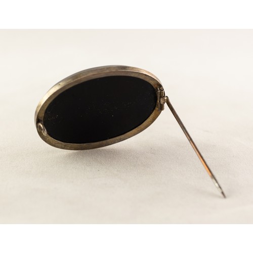 115 - FRAMED OVAL BLACK MARBLE BROOCH with good micro-mosaic floral bouquet inlay, 1 1/2in (4cm) wide