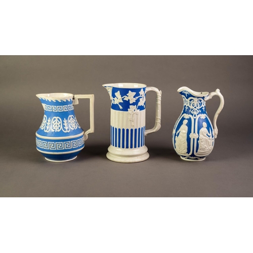 12 - WILLIAM BROWNFIELD OR ATTRIBUTED TO, THREE NINETEENTH CENTURY RELIEF MOULDED POTTERY JUGS IN BLUE AN... 