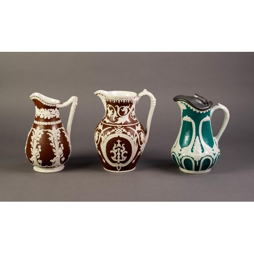 13 - WILLIAM BROWNFIELD OR ATTRIBUTED TO, TWO NINETEENTH CENTURY RELIEF MOULDED POTTERY JUGS IN BROWN AND... 