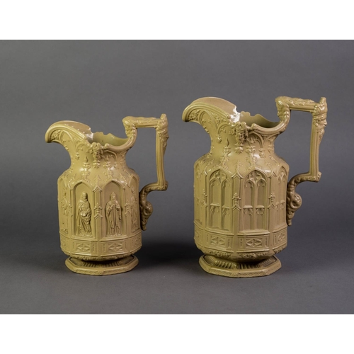 21 - TWO CHARLES MEIGH NINETEENTH CENTURY ‘GOTHIC’ RELIEF MOULDED BUFF GLAZED POTTERY JUGS, the lager mou... 