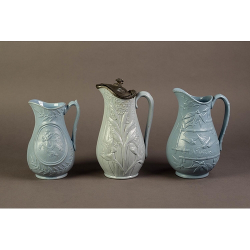 31 - DUDSON OR ATTRIBUTED TO, THREE NINETEENTH CENTURY RELIEF MOULDED AND BLUE GLAZED POTTERY JUGS, inclu... 