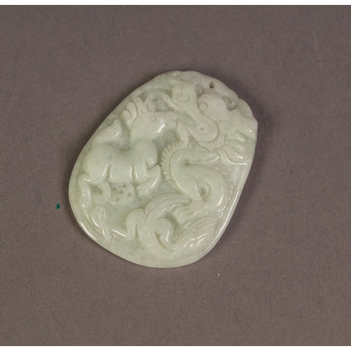 210 - CHINESE WHITE JADE OVULAR PENDANT, carved in bas relief with a dragon attacking a horse, flat back, ... 