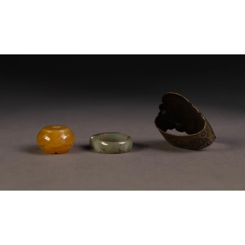 217 - CHINESE CARVED GREY JADE RING (ring size O/P); a fawn JADE OJIME with flower head carved top and a M... 