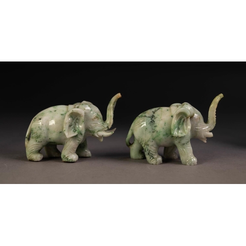 218 - PAIR OF CHINESE CARVED SPECKLED GREY/GREEN MODELS OF ELEPHANTS, with trunks raised, 2 1/4in (5.75cm)... 