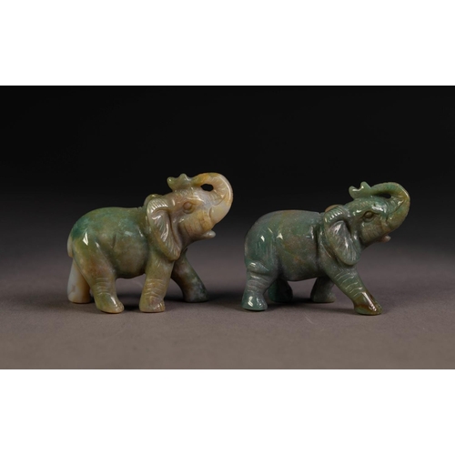 220 - PAIR OF GREY CARVED JADE WELL-MODELLED ELEPHANTS each with trunk folded back over their heads, 1 7/8... 