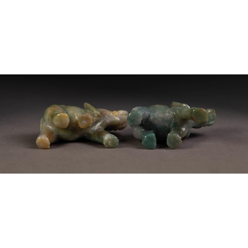 220 - PAIR OF GREY CARVED JADE WELL-MODELLED ELEPHANTS each with trunk folded back over their heads, 1 7/8... 