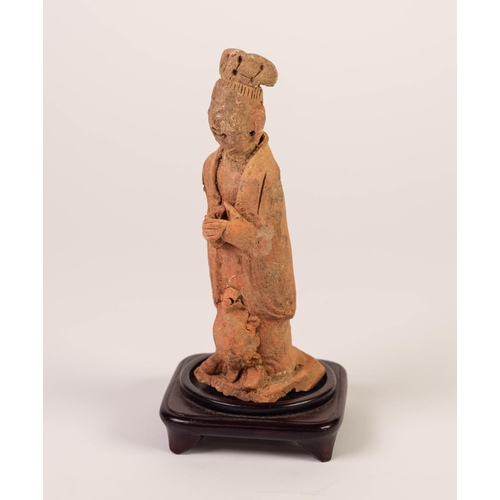 194 - AGED CHINESE TERRA COTTA FIGURE OF AN IMMORTAL, his hands clasped before him, a tortoise ascending f... 