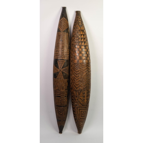 125 - PAIR OF AFRICAN CARVED SOFTWOOD CANOE SHAPED WALL HANGINGS, worked to the exterior with geometric de... 