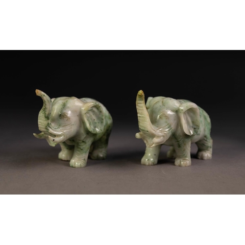 15 - PAIR OF CHINESE CARVED SPECKLED GREY/GREEN MODELS OF ELEPHANTS, with trunks raised, 2 1/4in (5.75cm)... 
