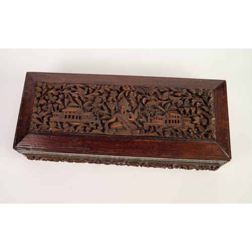 32 - EARLY TWENTIETH CENTURY INDIAN CARVED HARDWOOD AND IVORY INLAID OBLONG BOX, the hinge top with well ... 