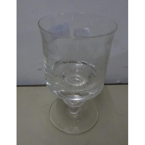 113 - A MODERN DIAMOND POINT ENGRAVED HOLLOW STEM DRINKING GLASS, SIGNED CHARLES TO THE FOOT
