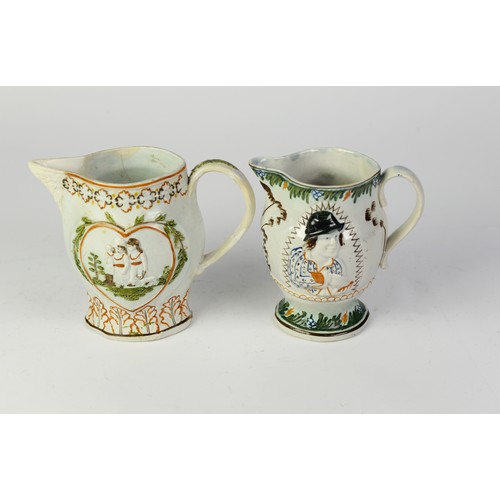 82J - TWO NINETEENTH CENTURY MOULDED PRATT WARE POTTERY JUGS, one of footed form with scroll handle, paint... 