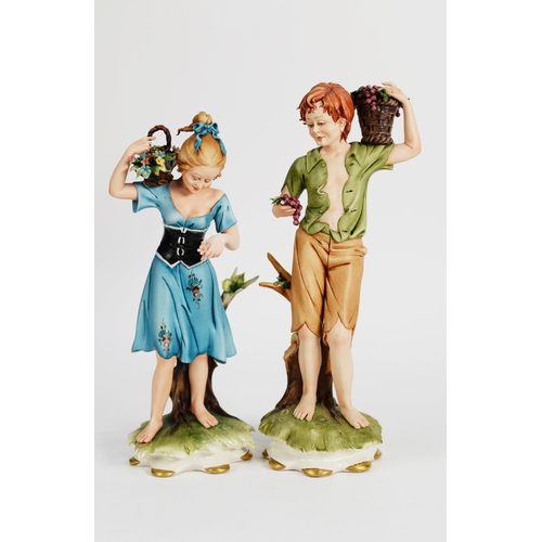 85 - PAIR OF MODERN CAPODIMONTE PAINTED BISQUE PORCELAIN FIGURES, he modelled carrying a basket of grapes... 